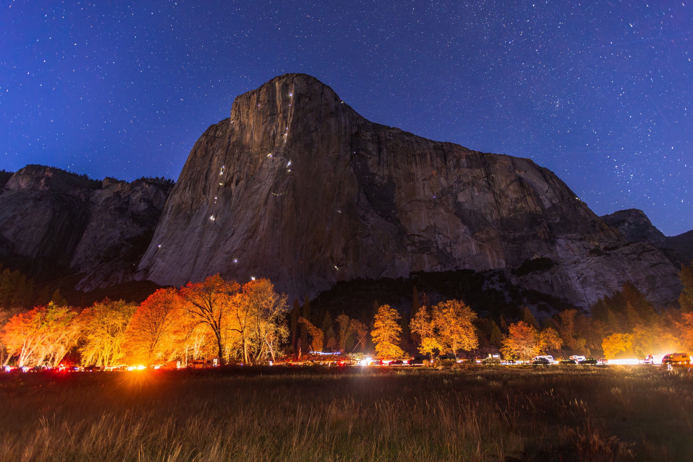 El Capitan under the stars above glowing fall trees in Yosemite Valley