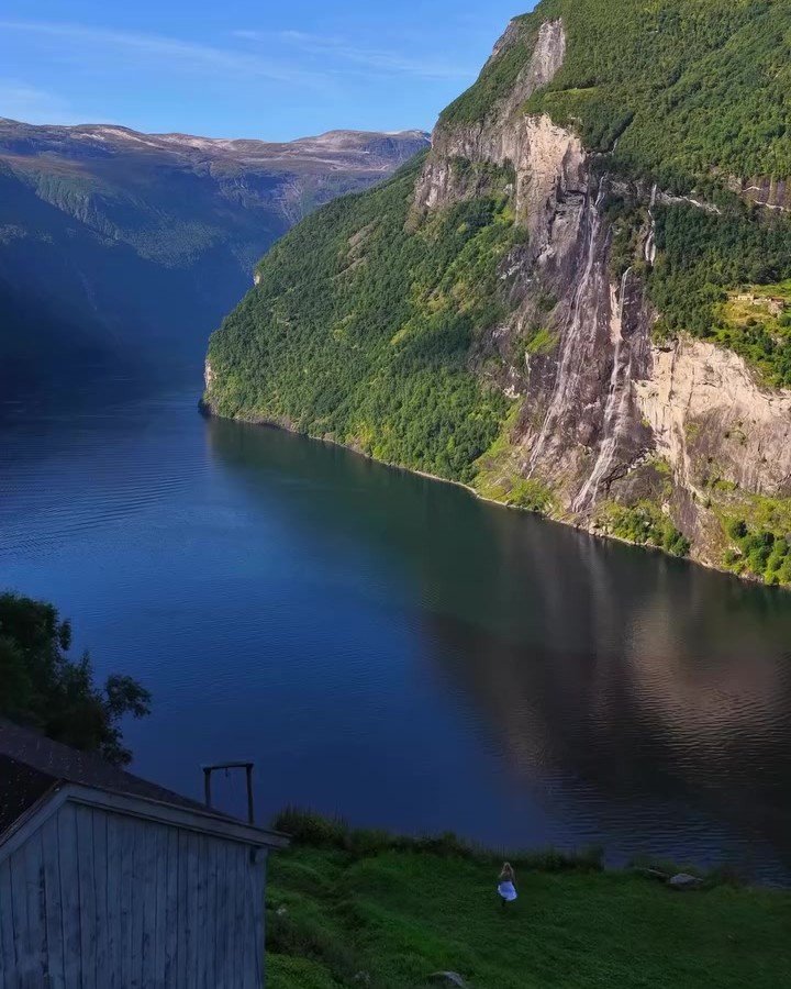 Norwegian fjord surrounded by steep green mountains