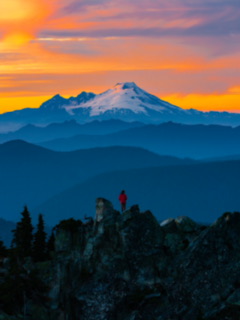A sunset hiker on a mountain ridge in Washington's Pacific Northwest.