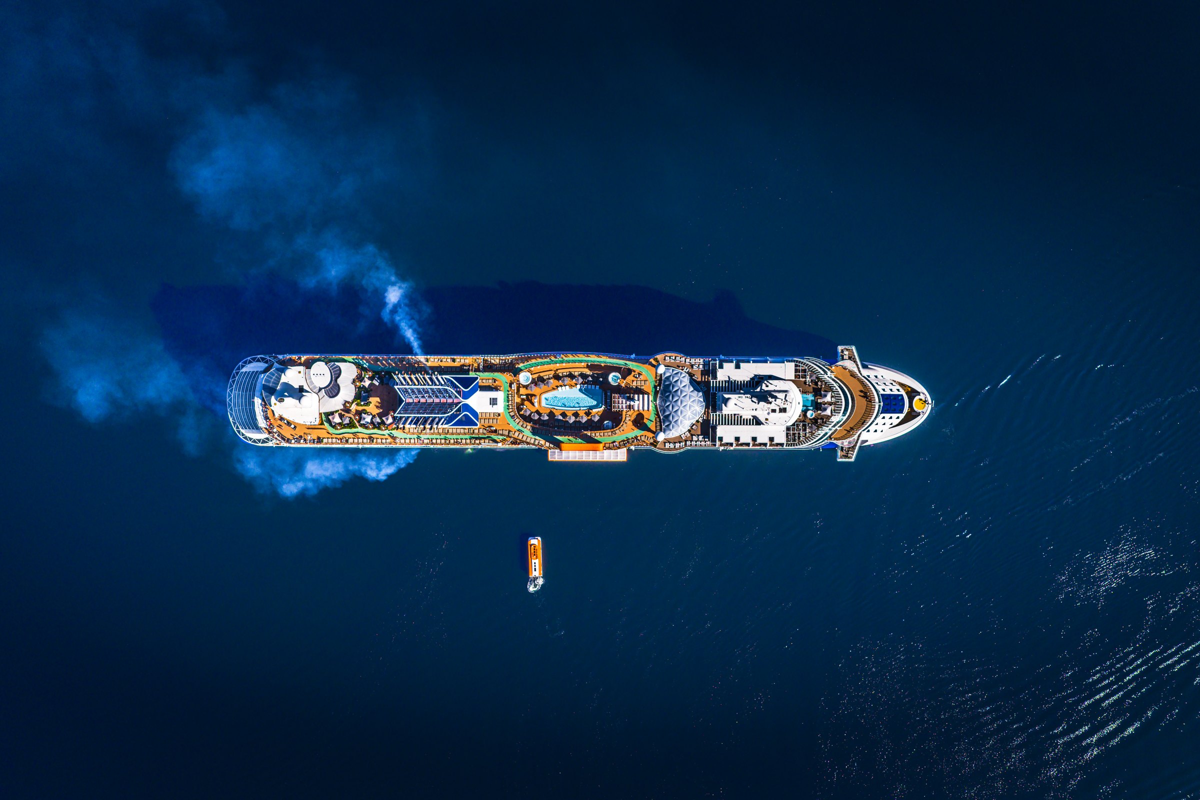 Celebrity Apex seen from directly above, sailing across deep blue open ocean