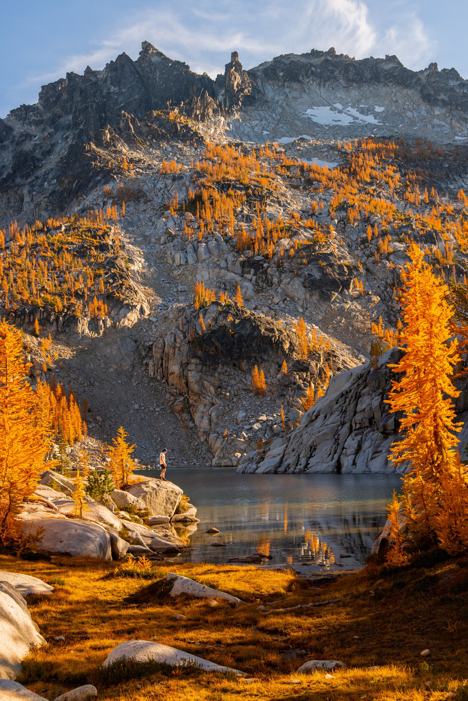 Golden larches below a granite peak above a lake in the Enchantments