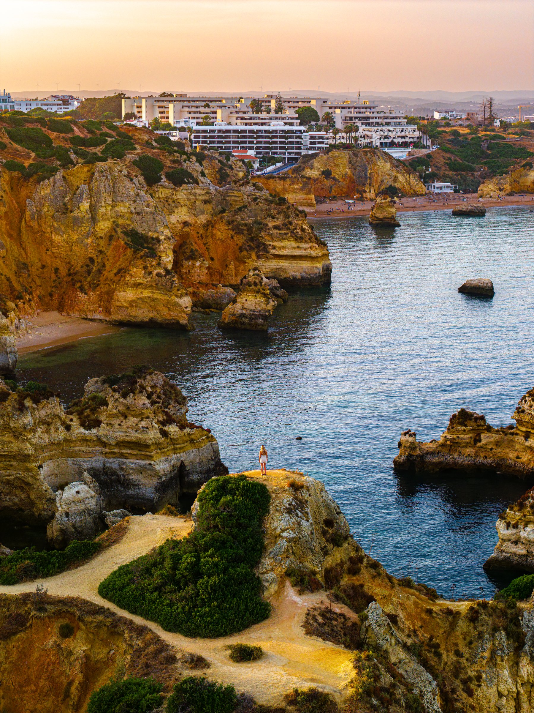 Golden hour over the cliffs, coves and turquoise water of the Lagos coastline